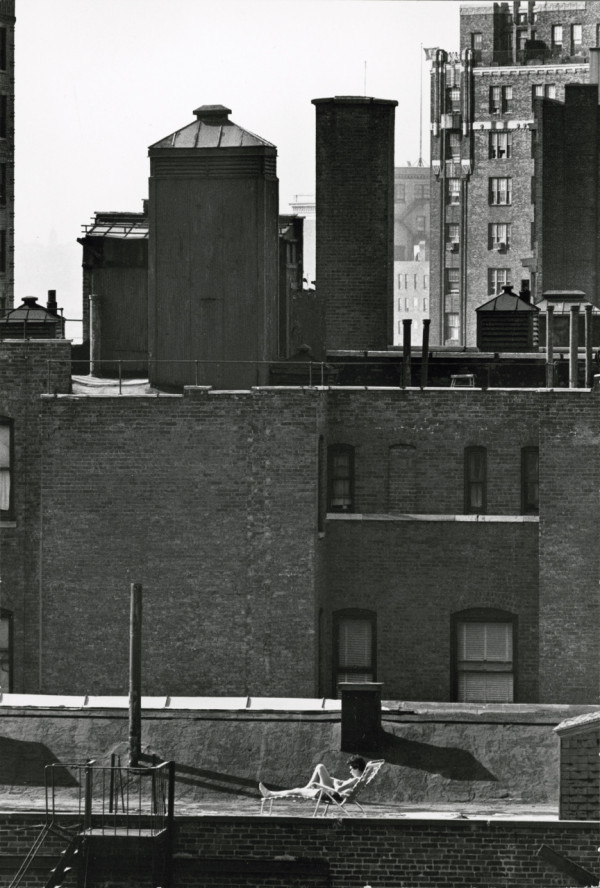 André Kertész – Untitled (woman sunbathing on roof reading), September 21, 1964